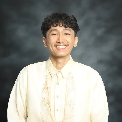 Karl Mercado smiling in a cream embroidered shirt